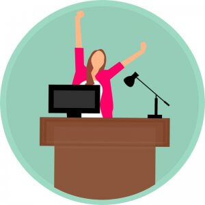 graphic-of-woman-with-arms-in-air-excited-for-weekend-while-at-her-work-desk-with-computer-and-lamp